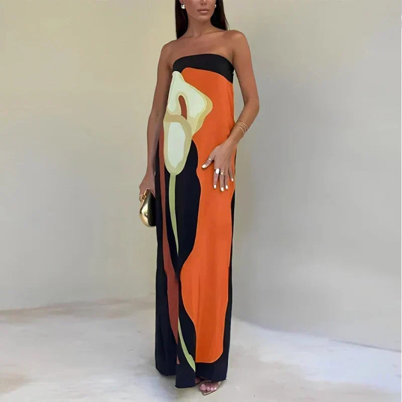 Off-shoulder strapless maxi dress with a vibrant summer print. Flowy women's dress for a chic holiday look.