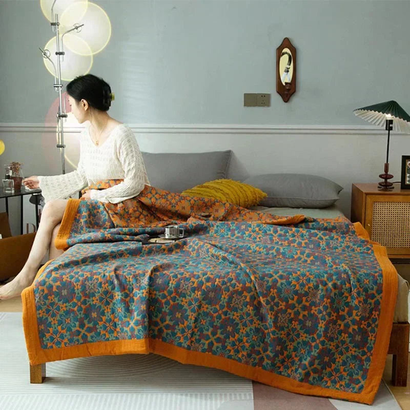 Vibrant orange & blue patterned six-layer cotton quilt. Reversible, cozy bedding for home decor.
