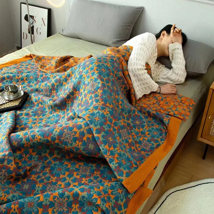 Plush six-layer cotton quilt in vibrant orange and blue. Eco-friendly, comfortable bedding for any bedroom.