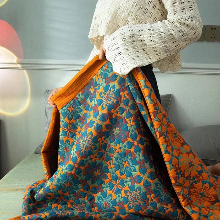 Reversible six-layer cotton quilt with a vibrant orange & blue pattern. Eco-friendly bedding for ultimate comfort.