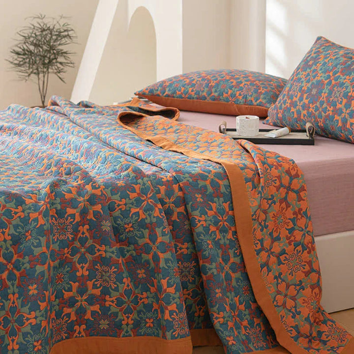 Vibrant orange & blue patterned six-layer cotton quilt. Reversible, cozy bedroom duvet for modern homes.