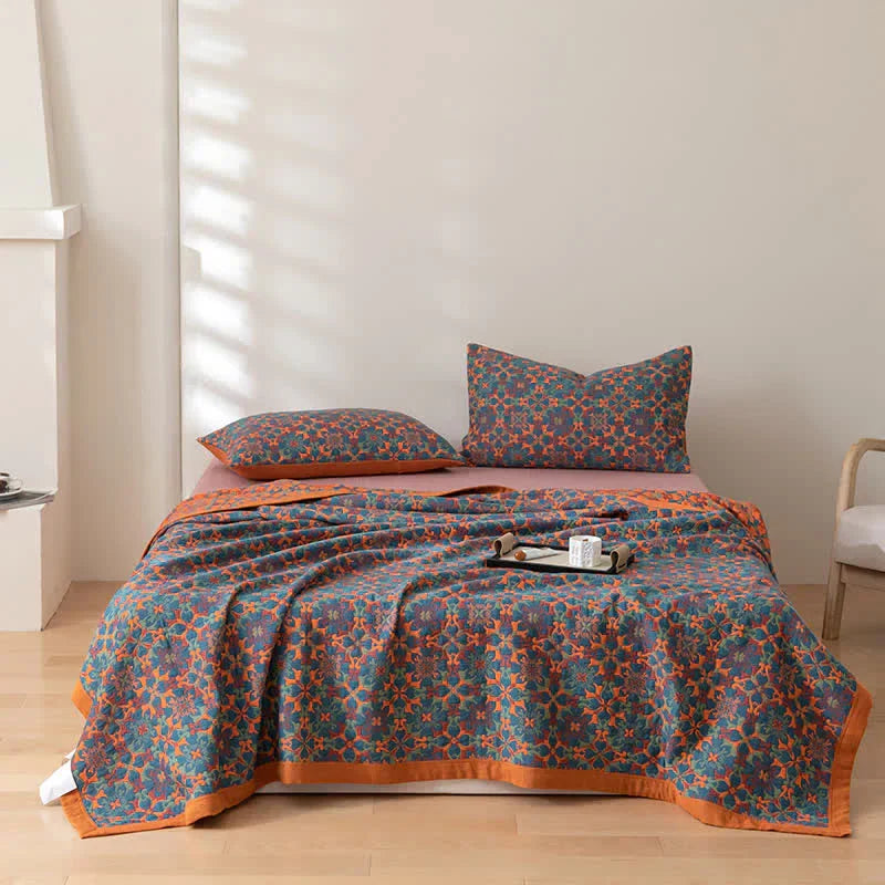 Soft six-layer cotton quilt featuring a vibrant orange and blue pattern. Reversible, cozy bedding for comfort and style.