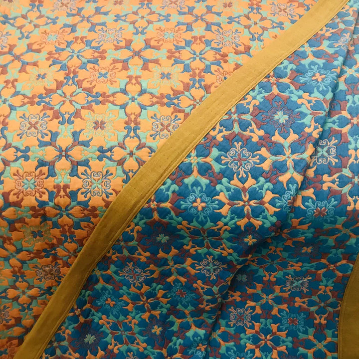 Luxurious six-layer cotton quilt in vibrant orange & blue. Perfect reversible bedding for a comfortable, stylish bedroom.