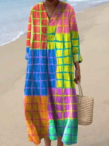 Elegant women's vibrant patchwork maxi dress, a flowy statement piece with long sleeves and a V-neck, great for holidays.
