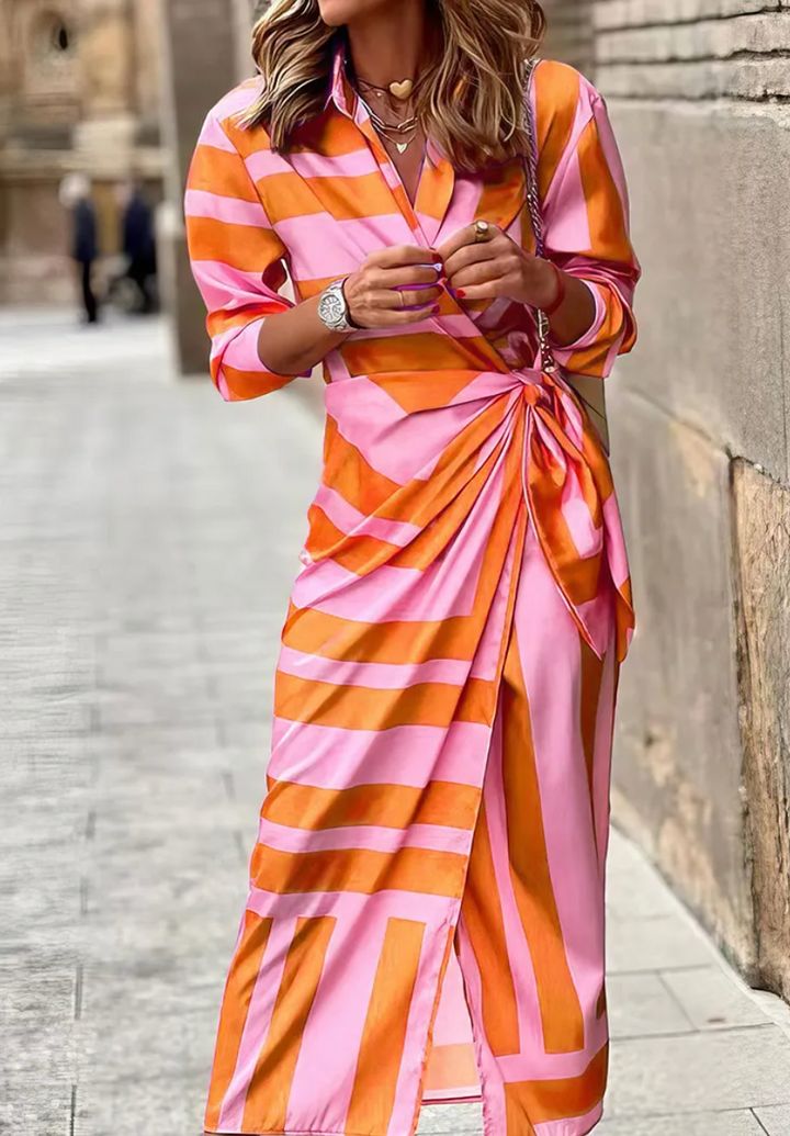 Women's vibrant printed wrap dress with collared neckline. Effortless fashion for summer events.
