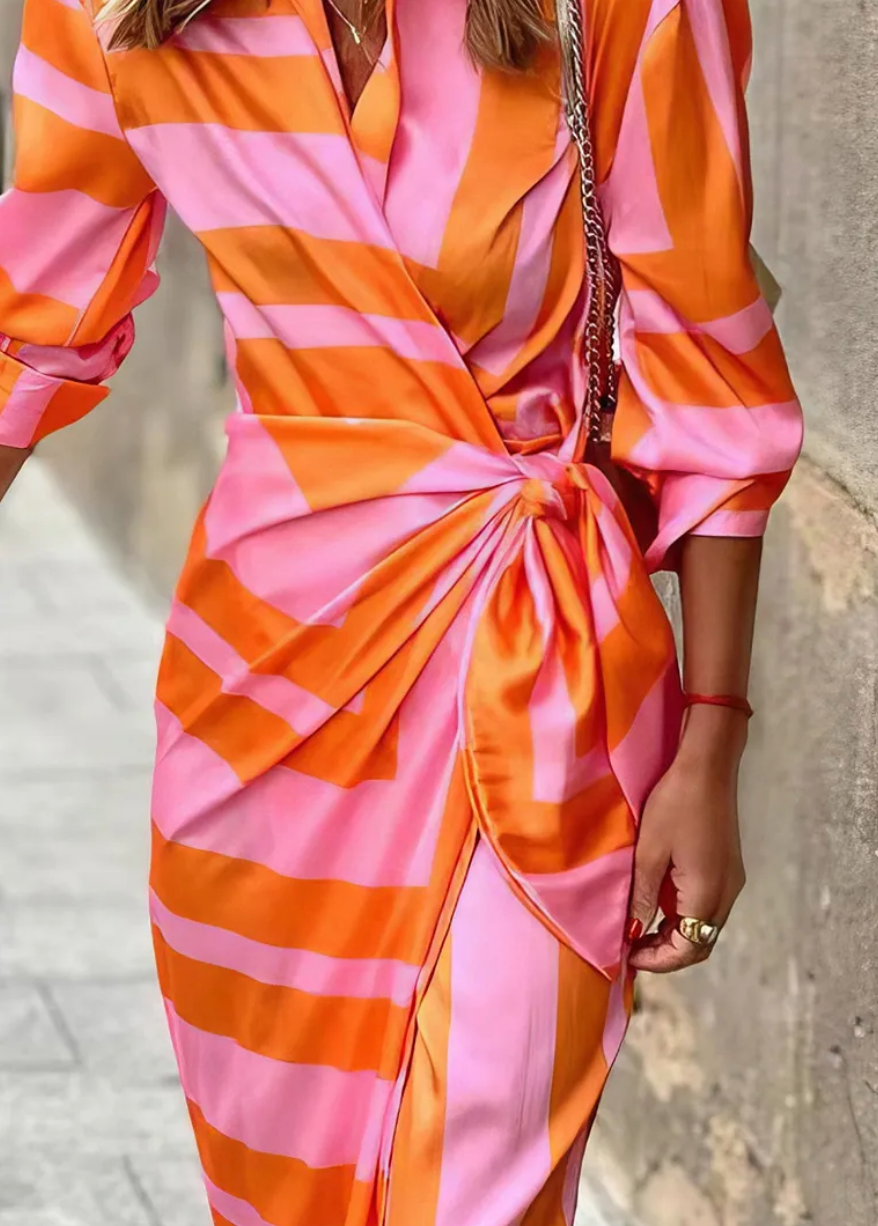 Casual elegant women's wrap dress. Vibrant printed design, ideal for summer fashion.