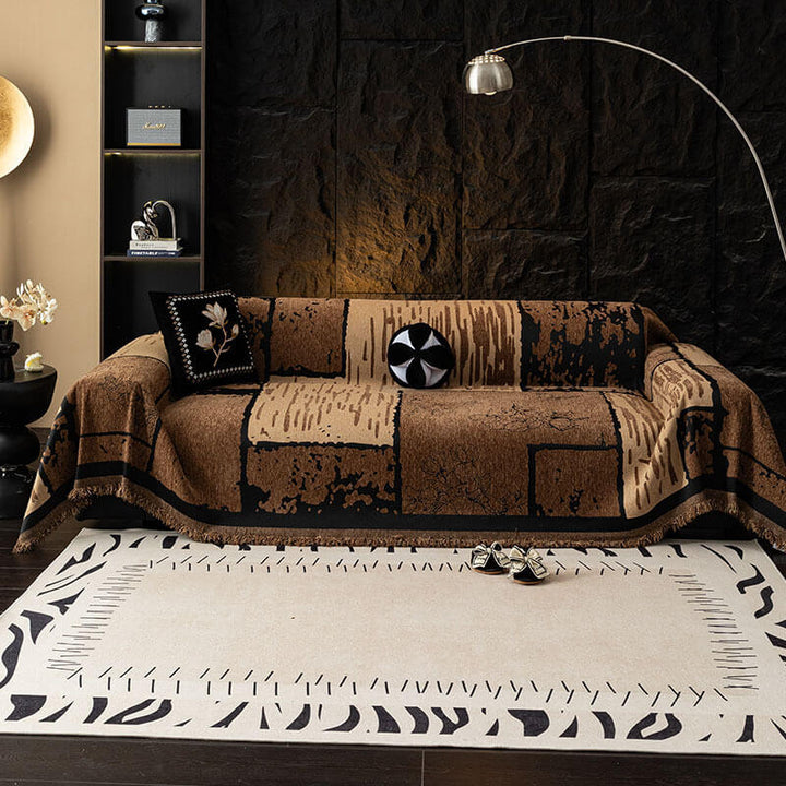 Full view of a living room with a vintage chenille sofa protector throw covering a three-seater couch