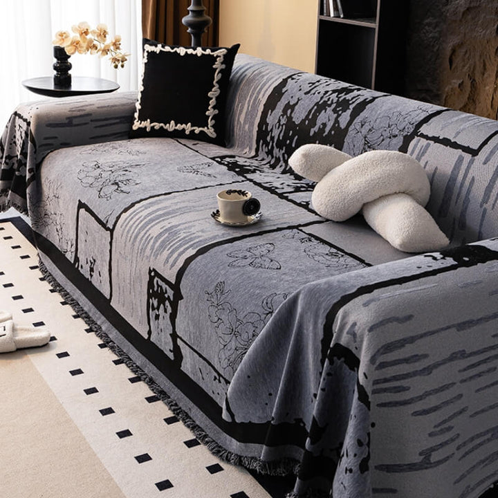 Corner detail of a sofa covered with a vintage chenille protector, showcasing elegant home decor