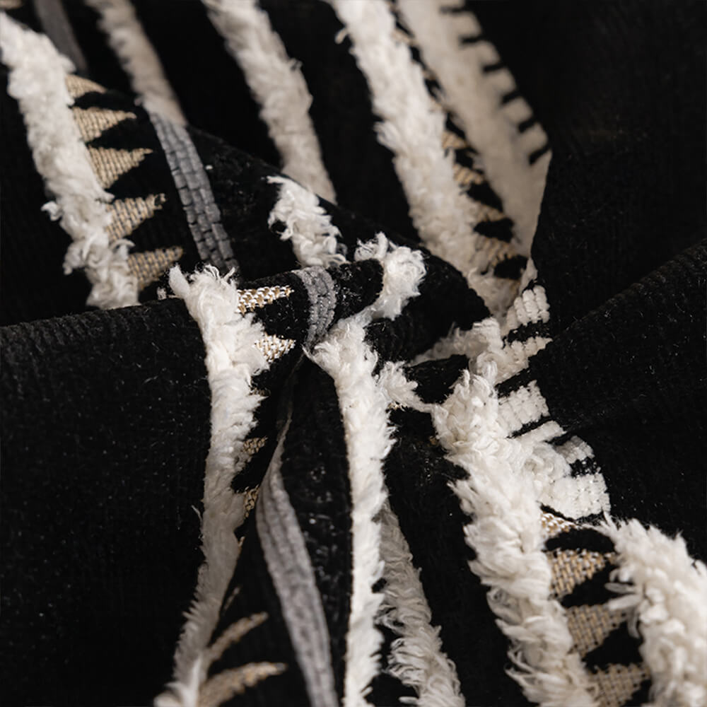 Close-up of vintage jacquard chenille fabric on a couch cover, showcasing intricate pattern and texture.