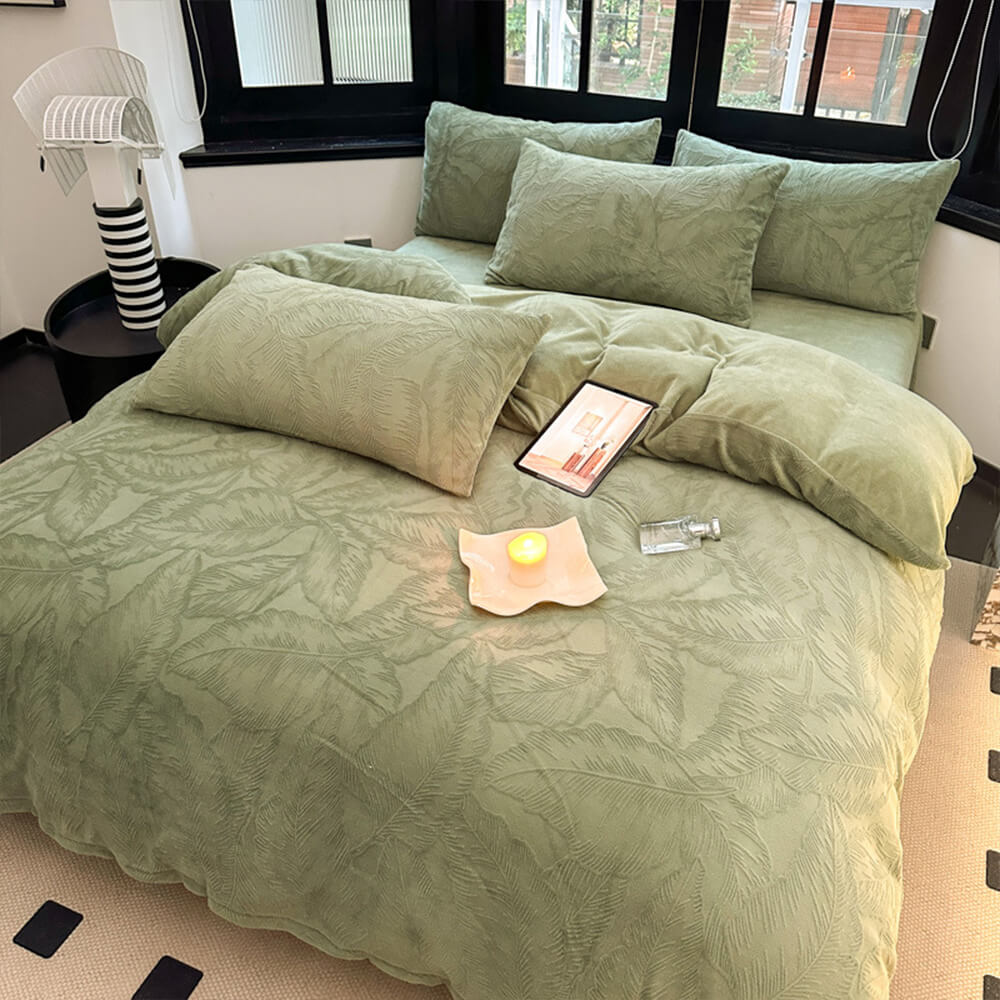 Warm embossed milk velvet bed sheet set with natural leaf pattern, cozy bedroom decor.