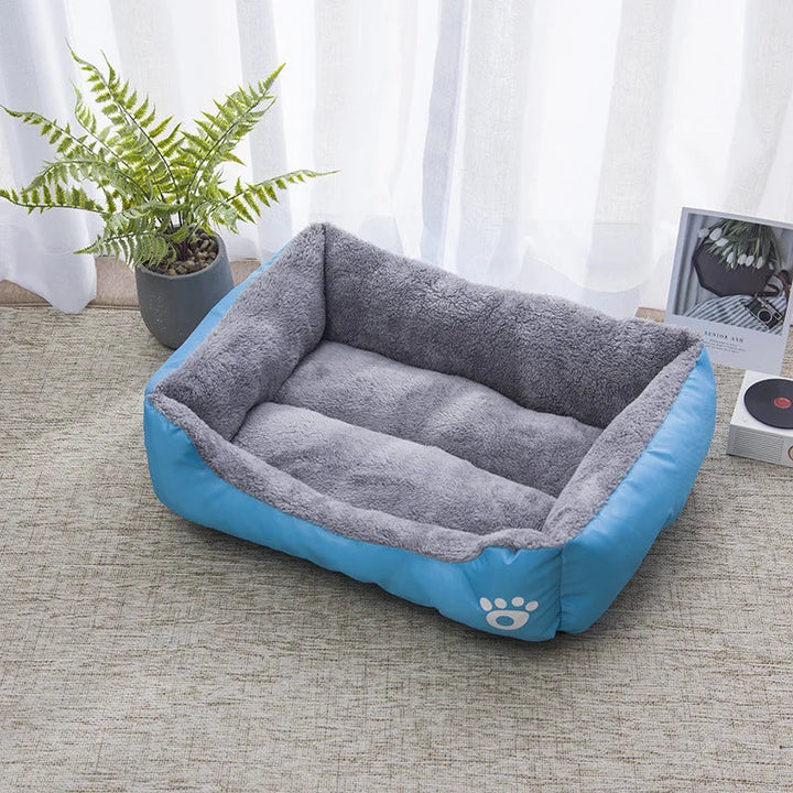 Warm gray waterproof bolster dog bed, plush for winter comfort, with high sides for support.