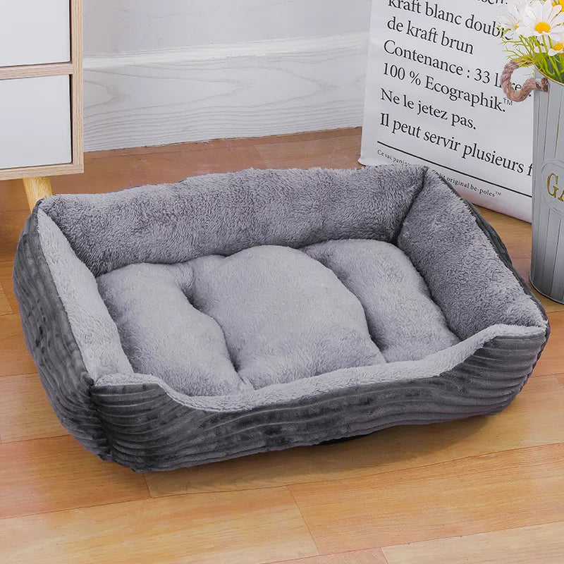 Stylish gray bolster pet bed offering waterproof protection and cozy warmth for pets in winter.