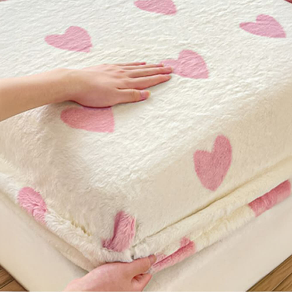 Full view of a bed with a plush milk velvet fitted sheet and two pillowcases, winter comfort.