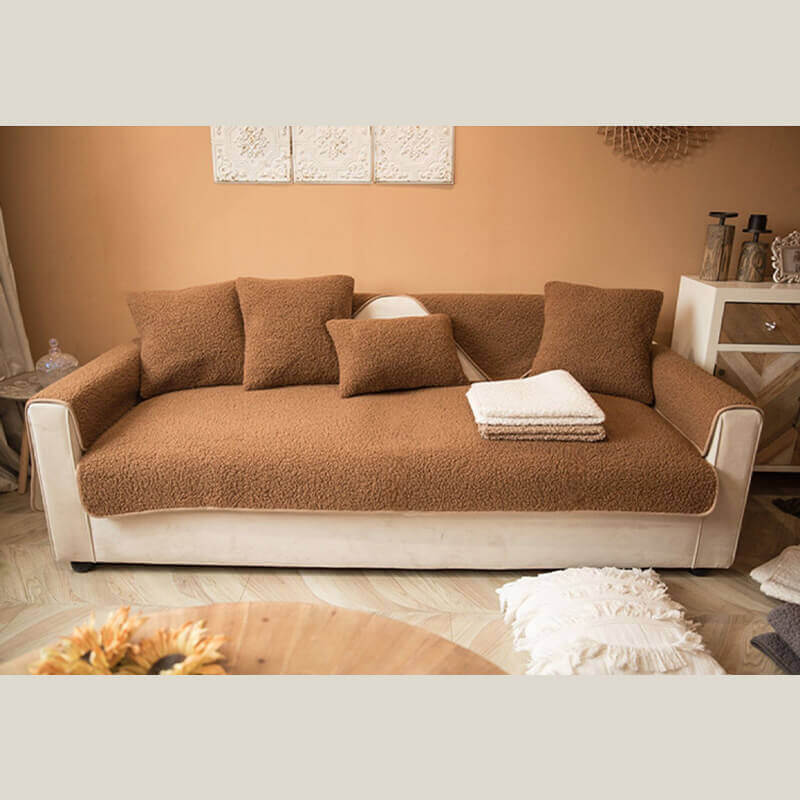 Plush teddy fleece non-slip sofa cover draped over a corner sectional, cozy and practical.