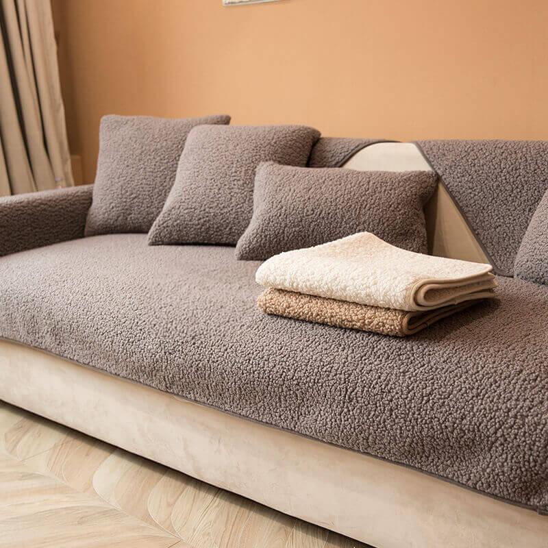 Soft cream teddy fleece couch cover, non-slip design, protecting a sofa, winter home essential.