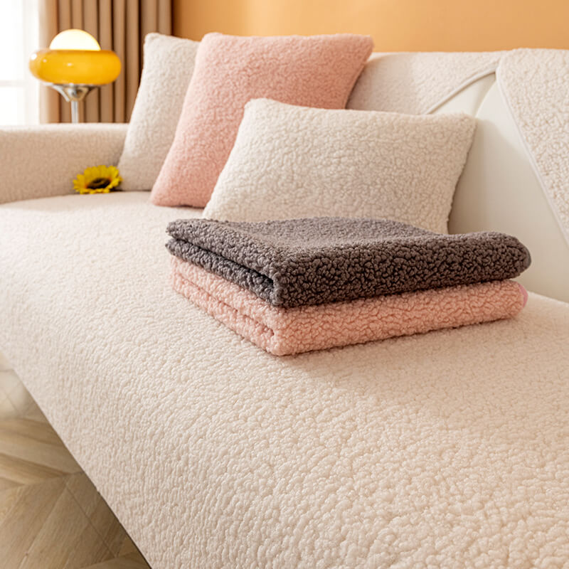 Full view of a living room with a beige teddy fleece non-slip sofa cover, cozy winter decor.
