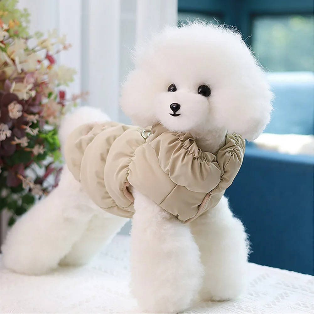 A dog wearing a pink fleece-lined winter coat, showing off its comfortable design for cool days.