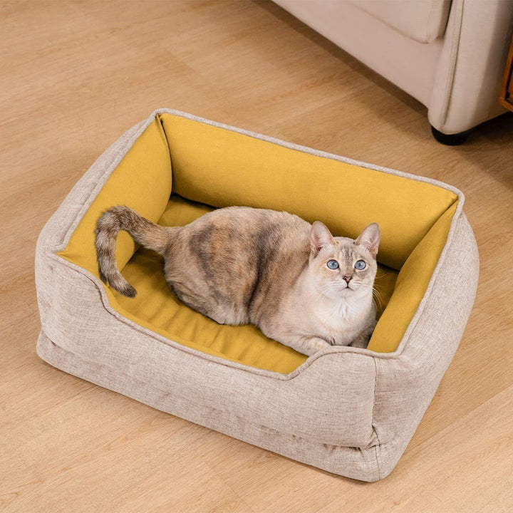 Washable bolster pet bed for cats, non-slip base, soft comfort for feline relaxation