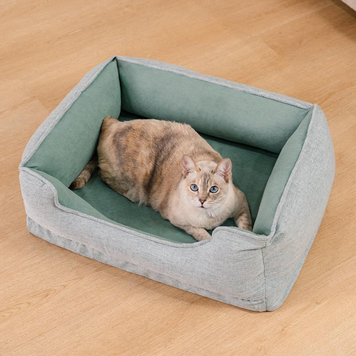 Grey washable cat bed with bolster cushion, non-slip bottom, ideal for pet comfort