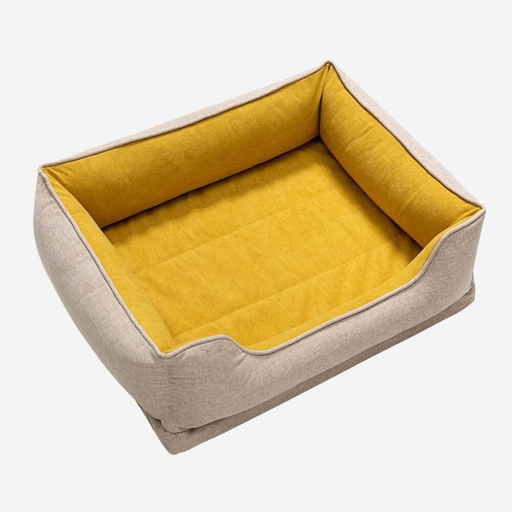 Cat resting comfortably on a bolster pet bed, washable non-slip design for feline relaxation