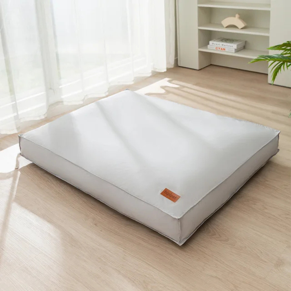 Water-resistant dog bed in a living room, durable and easy-clean for pet comfort.