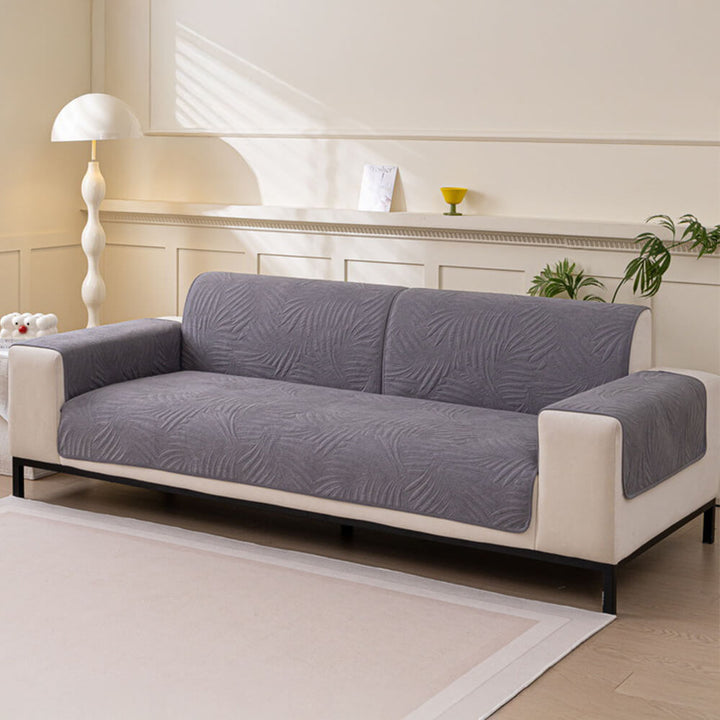 Elegant water-resistant couch cover with a textured quilted design and reliable non-slip backing