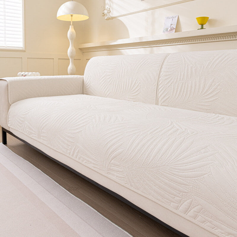 Close-up of the quilted pattern on a water-resistant sofa cover with its non-slip backing visible