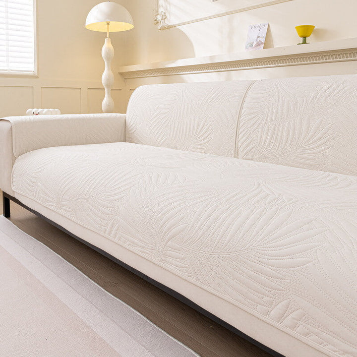 Close-up of the quilted pattern on a water-resistant sofa cover with its non-slip backing visible