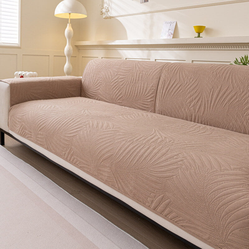 Beige water-resistant couch protector with non-slip backing, offering durable furniture protection