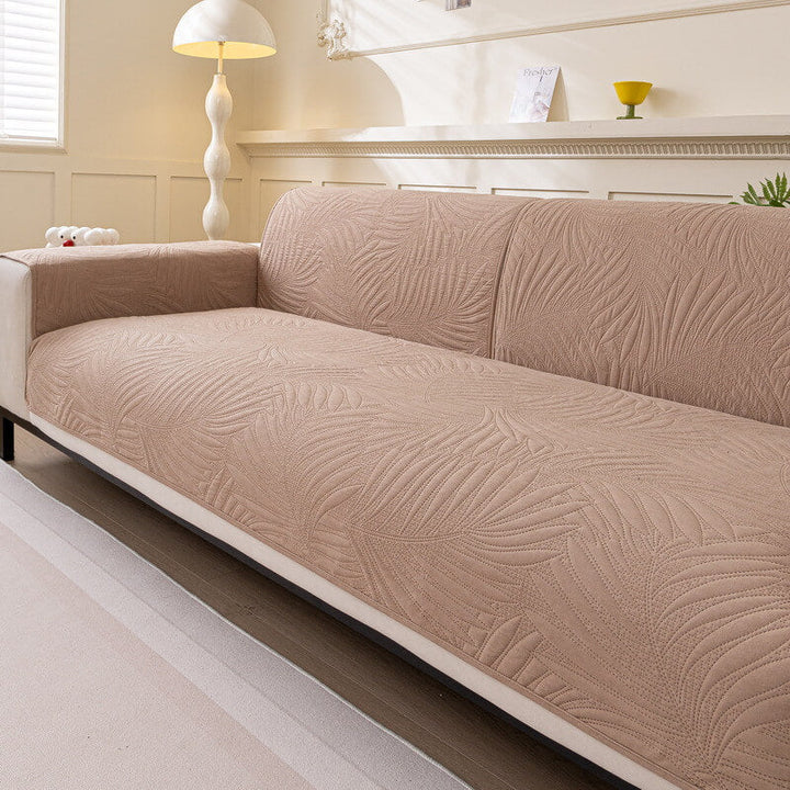 Beige water-resistant couch protector with non-slip backing, offering durable furniture protection