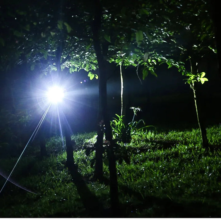 Black 2000-lumen LED headlamp with adjustable zoom for night dog walking and outdoor activities.