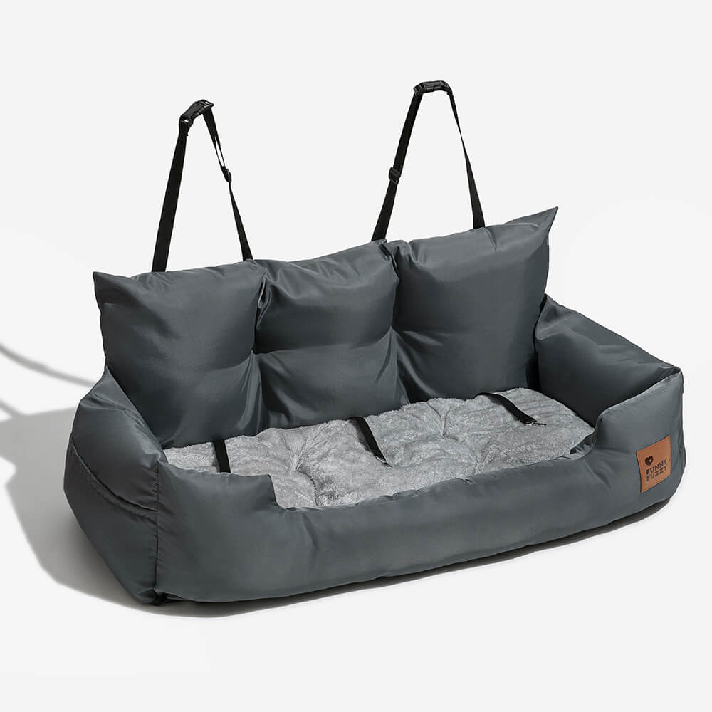 Large dog looking out window from secure waterproof car seat bolster bed
