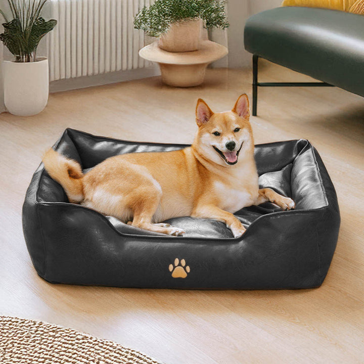 Waterproof faux leather dog bed showcasing its stain resistant surface, ideal pet sofa for active dogs