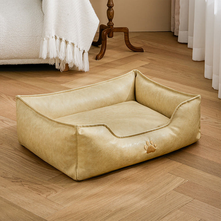 Waterproof faux leather dog bed with an integrated pillow design, ultimate comfort for pets