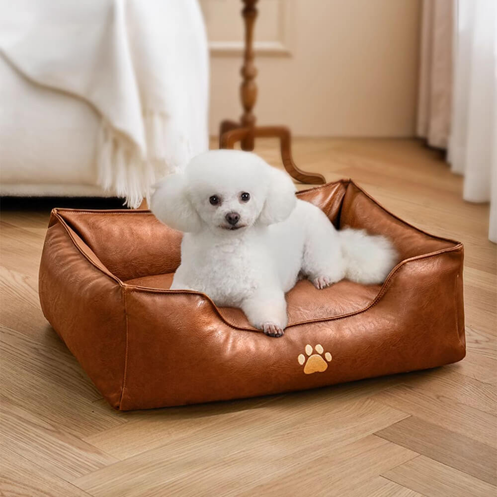 Detail of the supportive bolster on a waterproof faux leather dog bed, comfortable pet furniture for aging dogs