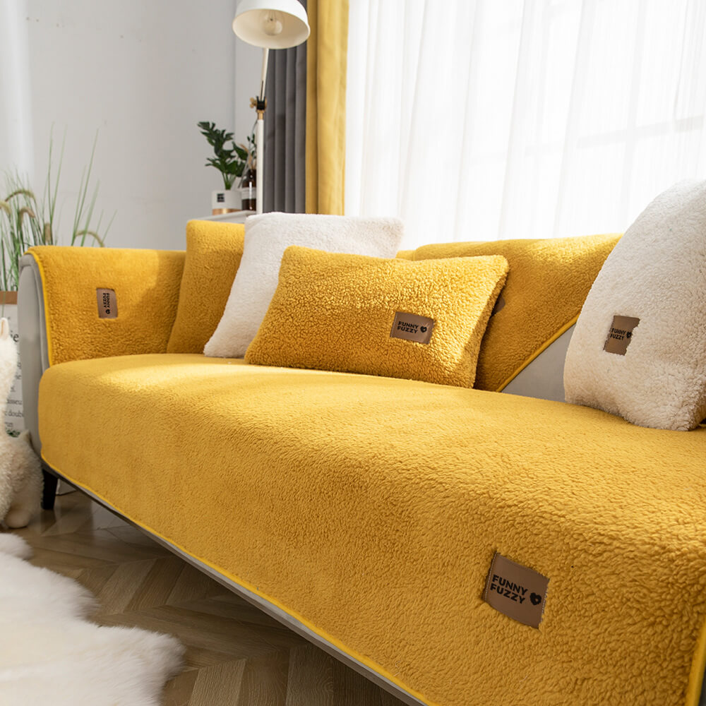 Folded waterproof sherpa fleece sofa protector, highlighting its soft texture and anti-slip backing