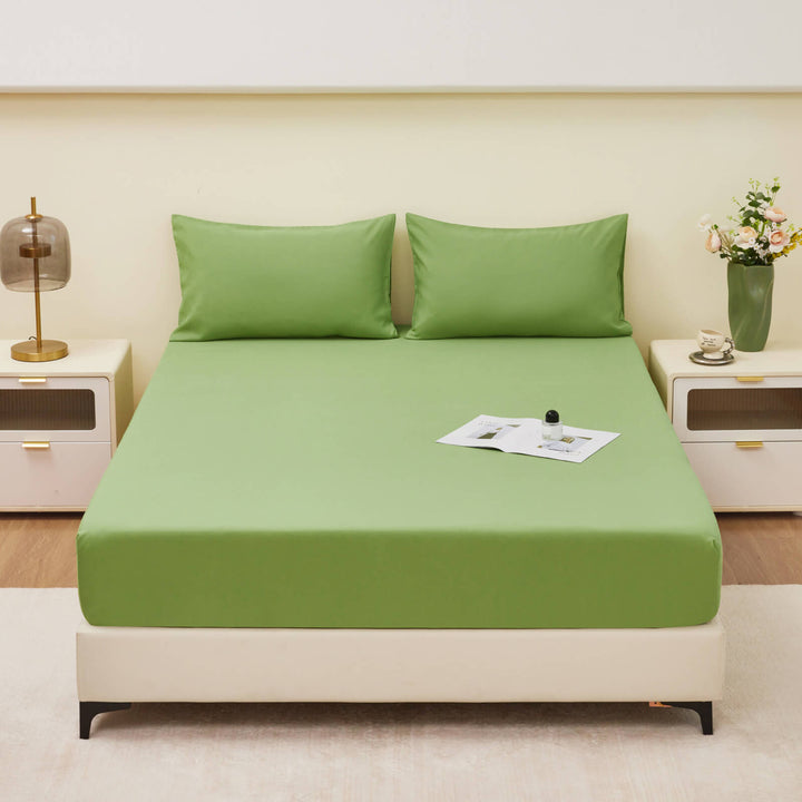 Hand touching a waterproof fitted sheet, illustrating the skin-friendly material and softness.