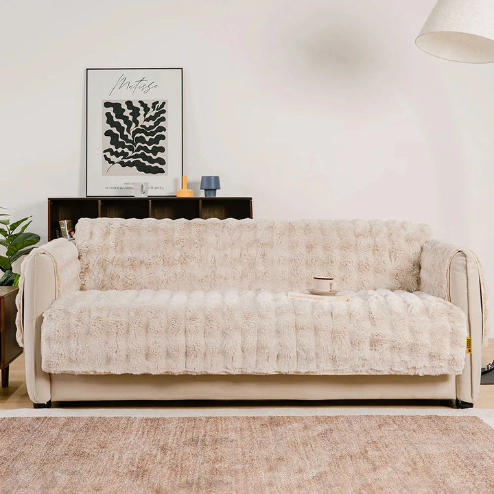 Folded waterproof fluffy couch cover, demonstrating its soft texture and compact storage.