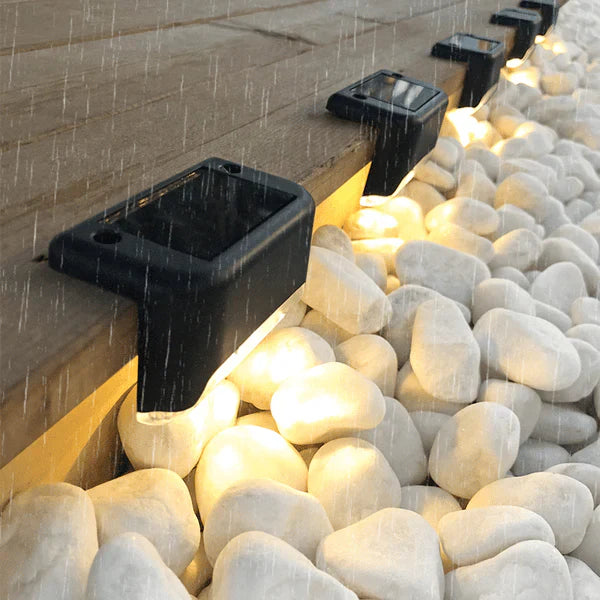 Wireless solar deck light with warm LED glow, perfect for garden path and fence lighting