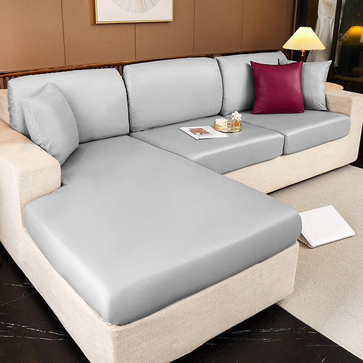 Waterproof sofa cover in gray for pets & kids, protecting a sectional couch from spills and scratches.
