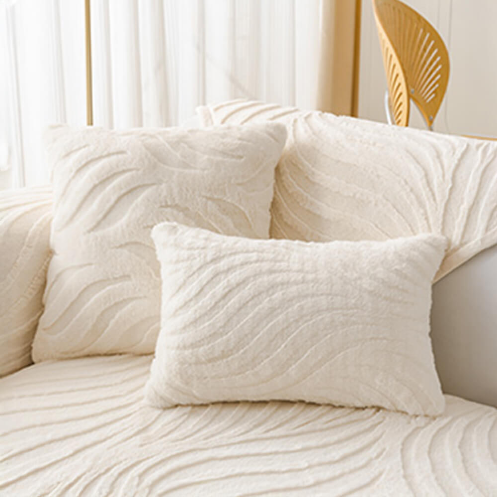 Multiple wave patterned plush non-slip couch covers stacked, showcasing colors.