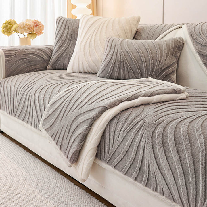 Deep blue wave plush non-slip couch cover draped over a sofa, enhancing home decor.