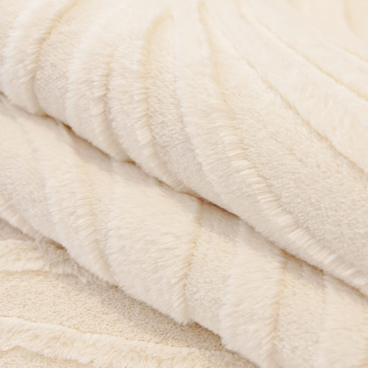 Detail of the non-slip backing on a wave textured plush sofa cover, secure fit.
