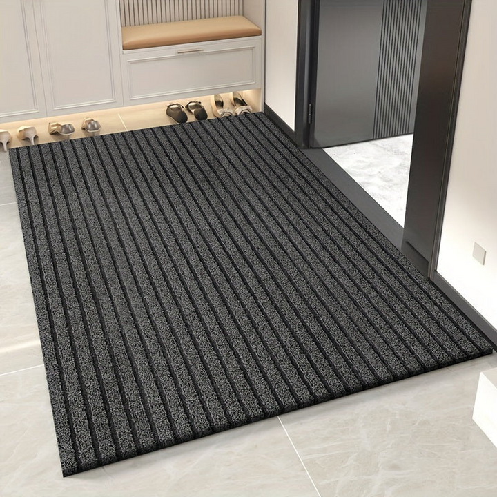 Weatherproof indoor/outdoor doormat for entryway. Durable, dirt-trapping utility mat keeps home clean.