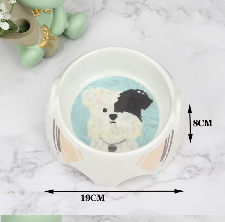 Adorably designed ceramic pet bowl for food and water, featuring a happy dog face. A great dog accessory.