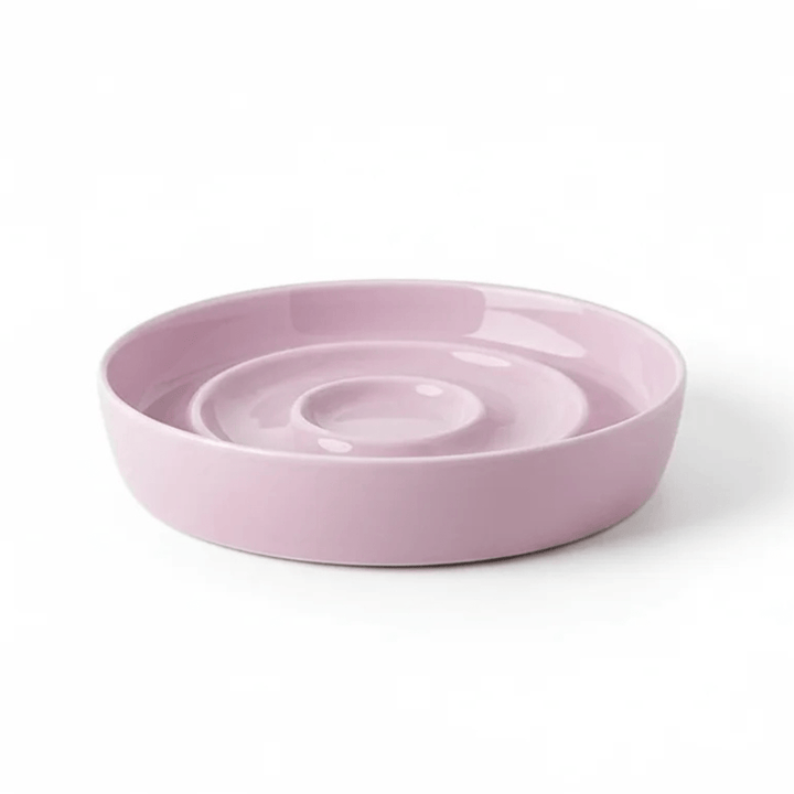 Top view of a ceramic slow feeder pet bowl with internal maze-like structure