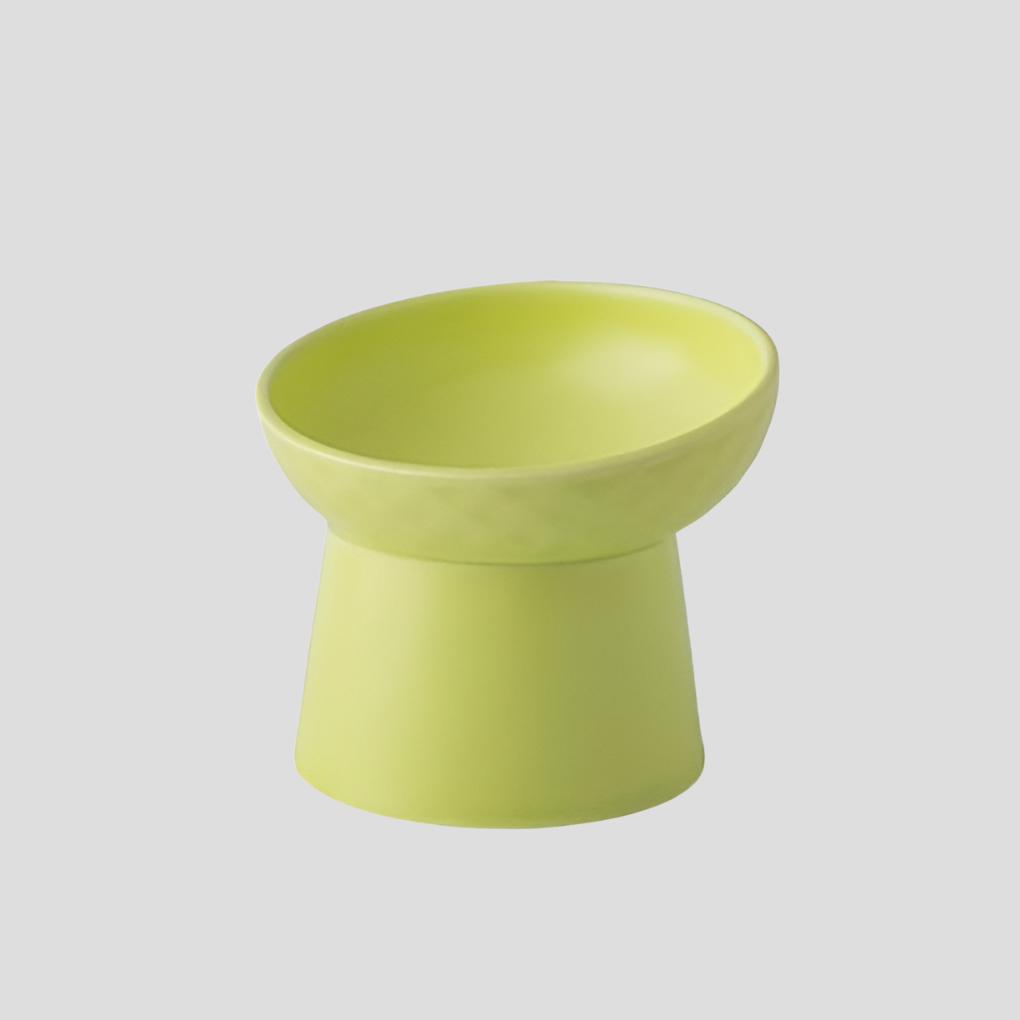 Tilted ceramic cat bowl on a clean surface, highlighting its easy-to-clean and durable design