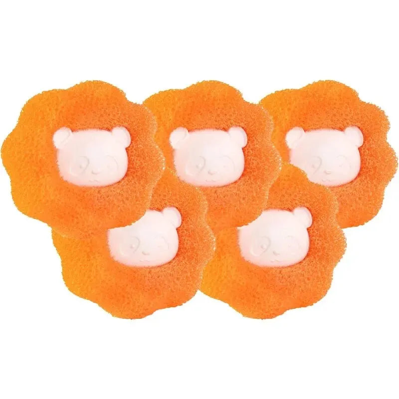 White reusable pet hair remover laundry balls with collected lint, shown in a washing machine.