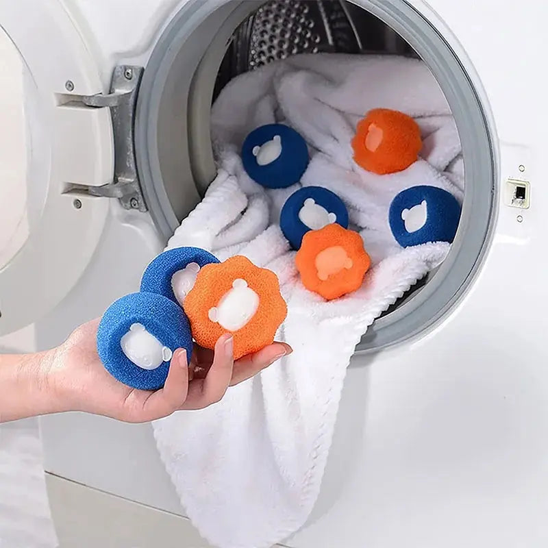 Three reusable lint catcher laundry balls in a pet owner's hand, ready for use in a washing machine.
