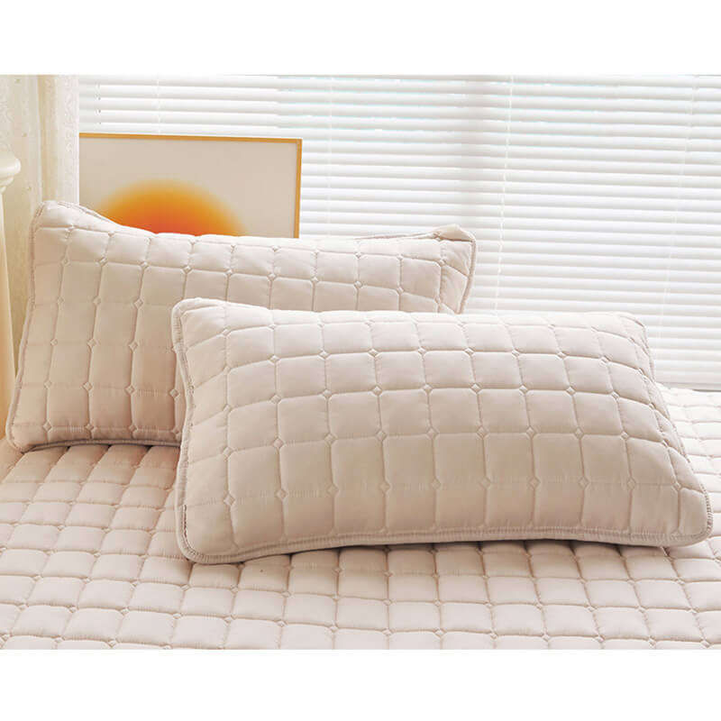 Hand touching the surface of waterproof mattress protector, feeling its soft, silent texture.